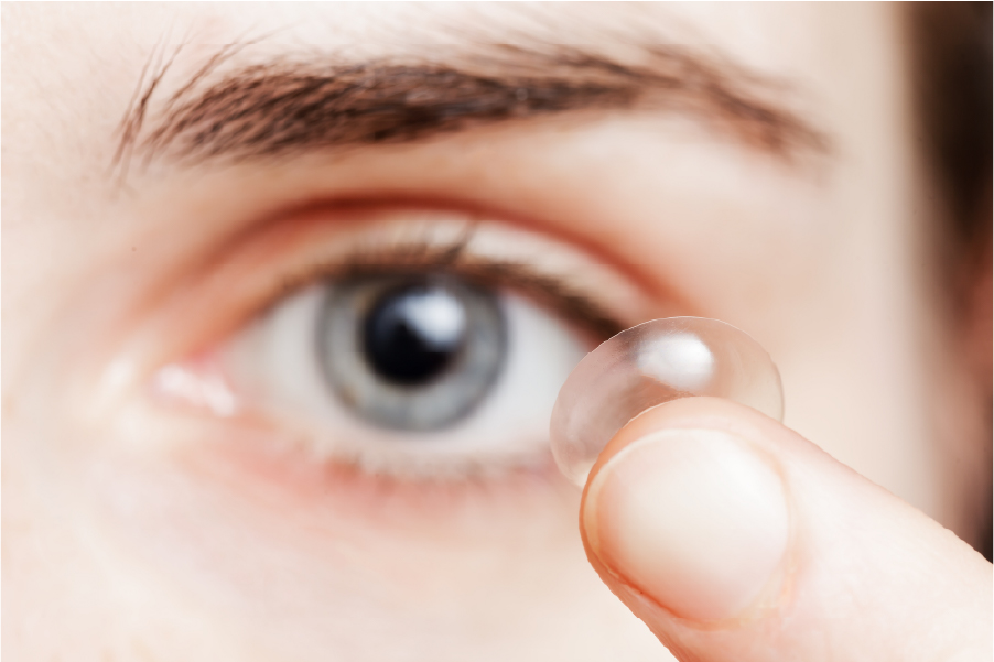 Person putting a contact lens in